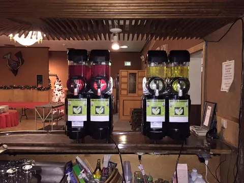 Two margarita machines on a bar at a party