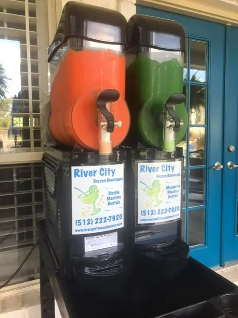 Orange and lime frozen drink machine on a patio