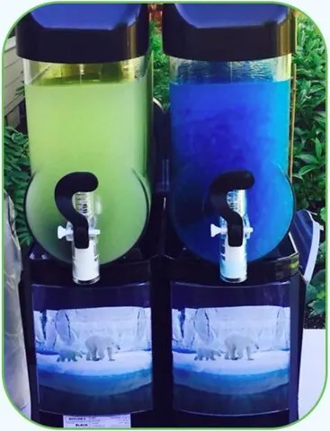 Lime and blue raspberry slushies in a two-bowl machine