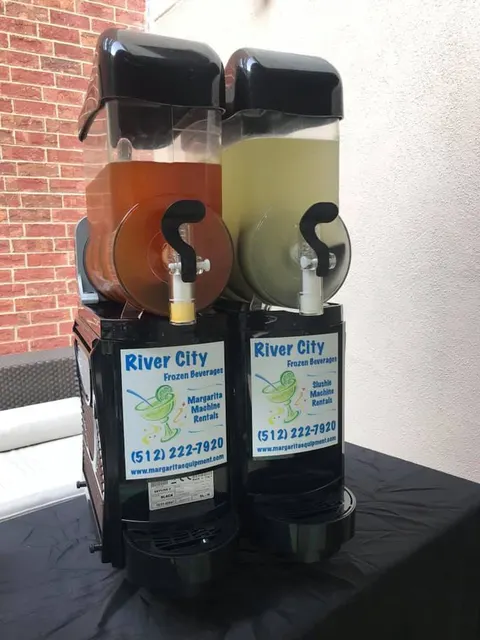 Orange and lime frozen drinks in a two-bowl machine