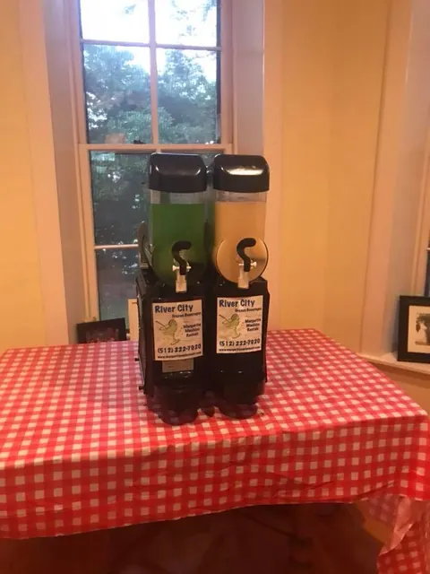 Margarita machine on a red checked tablecloth