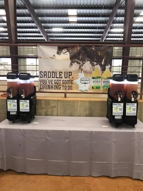 Two margarita machines at a western-themed event hall