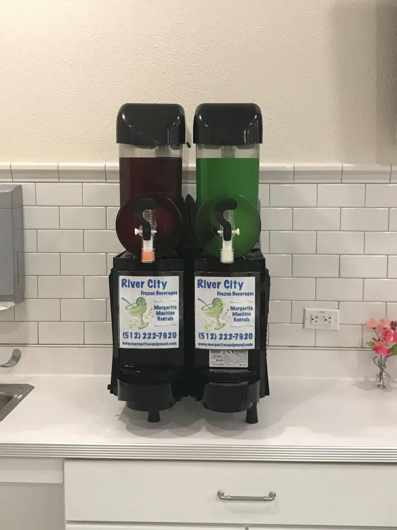 Margarita machine on a white tile kitchen counter